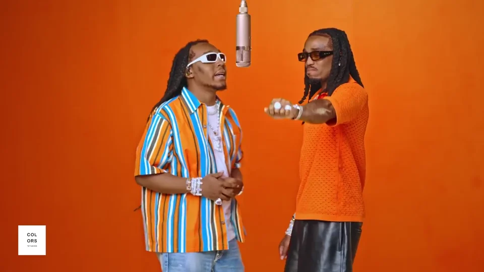 Orange-lit music video performance
